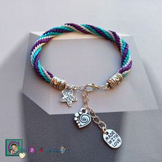 a bracelet with charms on it sitting on top of a table