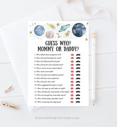 a printable guess who mommy or daddy? card with space themed design on it