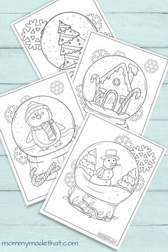 four christmas coloring pages with snowman and penguin in the snow globe, on top of a wooden table