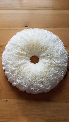 a white donut sitting on top of a wooden table