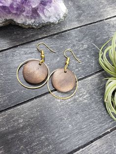 "These lightweight dangle earrings feature 18mm dark brown unfinished wooden discs dangling inside 25mm gold plated brass hoops. The ear wires are made of hypoallergenic gold plated surgical steel, making these earrings safe for sensitive ears! They are super lightweight, each weighing only 0.1 ounce. They measure approximately 1.75 inches from the top of the ear wires to the bottom of the gold hoop. Domestic shipping is always free here at Mayamadethis! When will my item ship? Every single item Minimalist Brown Hoop Earrings For Gift, Brown Round Earrings For Pierced Ears, Brown Small Hoop Earrings With Ear Wire, Wooden Round Earrings For Gifts, Round Wooden Earrings For Gifts, Round Wooden Earrings As Gift, Wooden Round Earrings Gift, Brown Round Hoop Earrings For Gift, Brown Wooden Dangle Jewelry