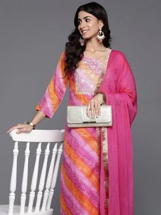 Grab this beautiful 3-piece set. The set comes with foil print, bandhani & zari embroidery kurta has round neck, 3/4th sleeves & calf length teamed with solid trouser pant with elasticated waistband and a slip-on closure and a silk chiffon dupatta with lace detailing. Color - Pink Kurta Fabric-Cotton Blend Bottom Fabric-Cotton Blend Dupatta Fabric - Silk Chiffon Neck-Round Neck Sleeves-3/4th Sleeves Work - Foil Print, Bandhani & Zari Embroidery Washing Instructions-Hand Wash DISCLAIMER - The color of the product may be differ due to screen settings of device. A misprint here and a color drop slip there is the beauty of printing which is not treated as a defect. Eid Bandhani Print Palazzo Set For Designer Wear, Eid Designer Palazzo Set With Bandhani Print, Diwali Bandhani Print Palazzo Set With Straight Kurta, Diwali Bandhani Print Semi-stitched Anarkali Set, Unstitched Bandhani Print Anarkali Set For Festive Season, Unstitched Bandhani Print Anarkali Set For Festive Occasions, Festive Straight Kurta Churidar With Bandhani Print, Festive Bandhani Print Palazzo Set For Diwali, Diwali Bandhani Semi-stitched Anarkali Set