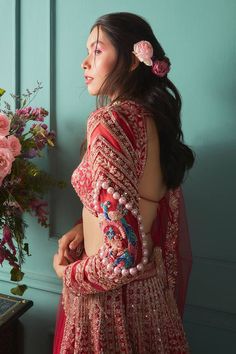 Red lehenga in raw silk base with zardosi and cutdana work, accented with pearl, french knot detailing and peacock motif at the hem along with attached cancan. Paired with a padded embroidered blouse and a net dupatta
Components: 3
Pattern: Embroidered
Type Of Work: Zardosi, Cutdana
Neckline: Round
Sleeve Type: Long
Fabric: Lehenga and Blouse: Raw Silk, Dupatta: Net
Color: Red
Other Details: 
Blouse:
Padded blouse
Back tie-up
Tassel detailed sleeves
Lehenga:
Attached cancan
Peacock motif embroid Cutdana Work, Peacock Motif, Raw Silk Lehenga, Wedding Sari, Net Lehenga, Red Lehenga, Traditional Indian Outfits, Lehenga Blouse, French Knot