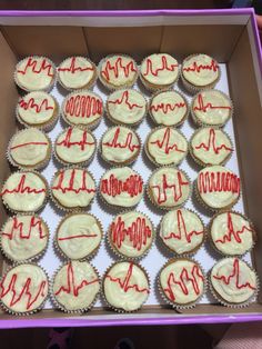 a box filled with cupcakes covered in white frosting