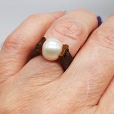 Elevate Your Style with Leather and Pearl Ring - A Captivating Fusion of Elegance and Artistry Step into a realm of unique elegance with our Leather and Pearl Ring, a masterpiece meticulously handcrafted by the artisans at PS121 Jewelry. This ring transcends mere adornment; it's a harmonious blend of natural beauty and artistic craftsmanship that resonates with your individuality and personal style. A Symphony of Elements: Adorn your finger with the exquisite interplay of leather and pearls, exp Leather Ring, Tanning Oil, Pearl Leather, Pearl Size, Handmade Design, Pearl Ring, Leather Jewelry, Freshwater Pearls, Leather