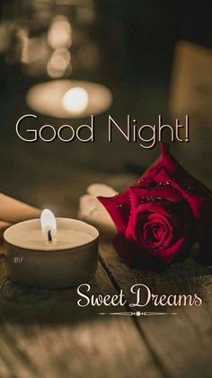 a candle and rose on a table with the words good night sweet dreams written in it