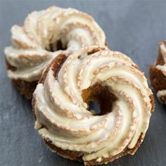 three donuts with frosting on them sitting on a table