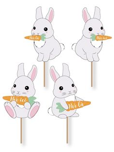 four rabbits holding carrots on sticks with the words mr and mrs written on them