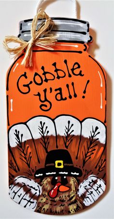 a wooden sign that says gobble y'all with a turkey wearing a hat