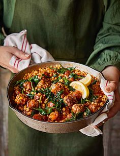 a person holding a pan filled with food