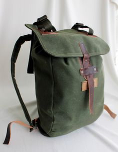 a green backpack sitting on top of a white table