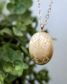 This gold filled locket is a beautiful, classic piece of jewelry now engraved with a delicate floral pattern. Select the light finish for a subtle engraving, reflecting in gold  or the darker fill to see the a bolder contrast accentuating the flowing lines along the locket surface. This will be a lasting heirloom that can be worn and treasured throughout the wonderful moments of your life.  ITEM DETAILS  * See listing photo for available Gold Filled locket sizes * Available in the classic polished or brushed matte style * Gold Filled chain * Engraving samples shown on: Top left to right: shiny light engraving, shiny dark engraving bottom left to right: matte light engraving, matte dark engraving  Additional engraving and photos can be purchased with this listing: http://etsy.me/1yX7s3S  HO Elegant Etched Yellow Gold Jewelry, Filigree Pendant Jewelry For Keepsake, Keepsake Yellow Gold Filigree Jewelry, Elegant Filigree Jewelry For Keepsake, Matte Gold Jewelry Gift, Formal Yellow Gold Filigree Locket Necklace, Dainty Engraved Pendant Locket Necklace, Elegant Filigree Locket Necklace As A Gift, Anniversary Filigree Yellow Gold Locket Necklace