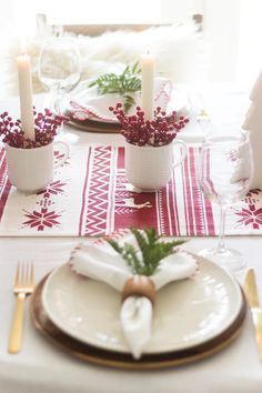 the table is set with candles and place settings