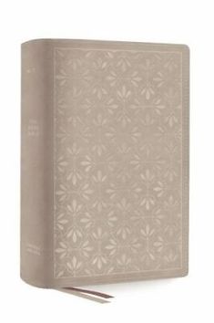 a beige book with an intricate design on the cover