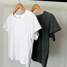 Meet the Darling Tee — It features a relaxed boxy silhouette that hits the waist perfectly, it offers gently distressed details and a 90's fade for true vintage connoisseurs. Crafted from locally sourced cotton, this tee combines a light, airy feel with a structured yet soft touch, making it comparable to a loved vintage tee. Used with the softest local 100% cotton* low gauge knit. Garment washed and dyed each tee for a beautiful natural worn-in look. Made in Los Angeles, USA Content: 100% Cotto Vintage Acid Wash Tops For Everyday Wear, Faded Summer Tops For Everyday, Basic Soft-washed Faded Top, Everyday Soft-washed Faded Tops, White Distressed Top For Everyday, Faded Short Sleeve Tops For Everyday, Basic Faded Relaxed Fit Tops, Basic Relaxed Fit Faded Top, Basic Faded Tops With Relaxed Fit