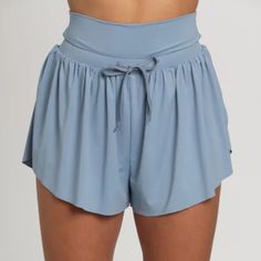 Best Selling Go-With-The-Flow Athletic Shorts Are Designed To Be Totally Versatile. The Smooth, Cool Athletic Material Can Handle Any Workout Or Is Comfortable For Everyday Wear. These Shorts Feature A Flowy, Butterfly Side Cut Design And A High Waisted Drawstring Waist Band. They Are Complete With Built-In Spandex Shorts With Side Pockets For Functionality. Spandex Lined Shorts Comfort Waist Band Drawstring Waist Tie Hidden Side Pockets Machine Wash Cold Wash With Like Colors Tumble Low Dry Do Workout Shorts With Pockets, Butterfly Shorts, Athletic Clothing, Xmas List, Side Cuts, Spandex Shorts, Athletic Outfits, Shorts Athletic, Cut Design