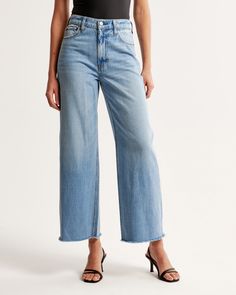 Our classic high rise cropped wide leg jeans in a medium wash with a raw-cut hem. This fit features a 10.5” high rise, is relaxed at the waist and hips, and eases into a wide, full-length leg shape with a cropped length. This jean is made from our super light drapey denim fabric, which features a super soft lightweight rigid denim. Medium Wash Cropped Jeans With Five Pockets, Cropped Denim Blue Flare Jeans With Frayed Hem, Cropped Denim Flare Jeans With Frayed Hem, Cropped Flare Jeans With Frayed Hem, Dark Wash Cropped Flare Jeans With Frayed Hem, Cropped Medium Wash Bottoms With Frayed Hem, Cropped Medium Wash Flare Jeans, Cropped Flare Jeans With Frayed Hem In Dark Wash, Cropped Dark Wash Flare Jeans With Frayed Hem