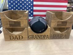 a baseball cap and hat stand in front of an american flag with the words dad, grandpa, papa on it