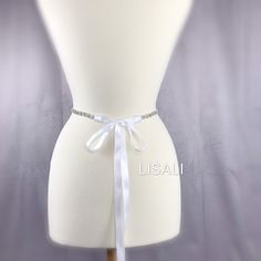 LISALI Skinny Wedding Dress Bridal Sash, Crystal Bridal Sash, Rhinestone Sash, Bridesmaid Belt, Wedding Dress Sash，Flower Belt This beatiful bridal sash is perfect for adding some bling to your dress! Made of - This beautiful sash is made with sparkly rhinestones details, very elegant. - The rhinestone portion is 16-34 inches long and about 0.4 inches wide. - satin ribbon - your color choice - the ribbon on the sash is a total of 100 inches long and it will fit sizes xs-xl. If you would like it White Bridal Belt For Bride, White Crystal Embellished Bridal Sash, White Rhinestone Sashes For Bridesmaids, White Rhinestones Bridesmaid Bridal Accessories, White Bridesmaid Sashes With Rhinestones, White Bridesmaid Sash With Rhinestones, White Satin Wedding Sash, White Satin Sashes For Wedding, Fitted Bridal Belt With Ribbon For Wedding