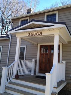 the front porch of a house with steps leading up to it