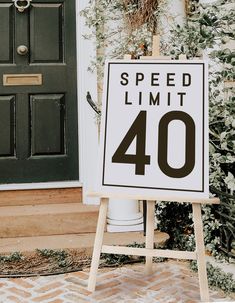 a speed limit sign sitting in front of a door