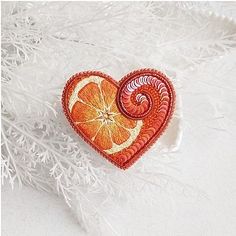 an orange slice in the shape of a heart on a white furnishing background