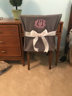 a chair with a monogrammed bow on it