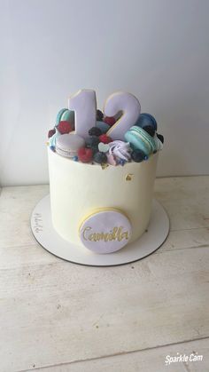 there is a cake that has the number twenty on it and decorated with candies