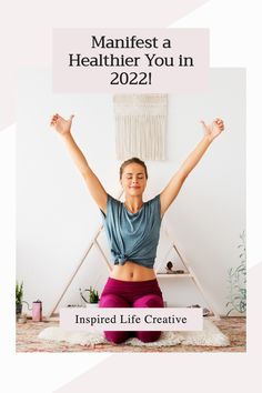 a woman sitting in the middle of a yoga pose with her arms up and hands raised