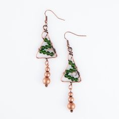 Get in the holiday spirit with the Holiday Wire Wrapped Tree Earrings. Featuring green glass beads arranged in a Christmas tree shape and wrapped in copper wire, these earrings add a festive touch to any look. Wire Wrap Ornaments, Christmas Tree Shape, Wire Wrapped Tree, Tree Earrings, Earring Tree, Tree Shapes, Copper Earrings, Wire Wrap, Copper Wire