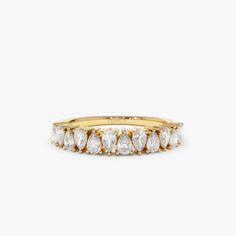 a yellow gold ring with five pear shaped diamonds on the front, and two rows of smaller pears in the middle