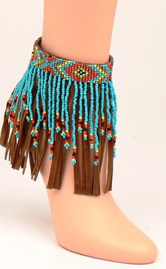 Boot Ankle Bracelet - Fringe Turquoise These ankle bracelets will certainly show your style. There is a tribal beaded band with beaded and leather fringe. Velcro closure. Bohemian Festival Bracelets With Dangling Beads, Bohemian Turquoise Beaded Bracelets With Dangling Beads, Bohemian Bracelets With Dangling Beads For Festivals, Adjustable Beaded Bracelets With Dangling Beads For Beach, Turquoise Bohemian Beaded Bracelets For Summer, Bohemian Bracelets With Dangling Beads, Southwestern Festival Beaded Bracelets, Brown Bracelets For Summer Festival, Summer Festival Turquoise Beaded Bracelets