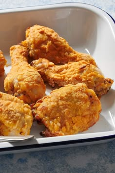 some fried food in a white dish with a spoon