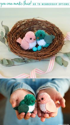 two small stuffed animals sitting on top of each other in front of a bird's nest