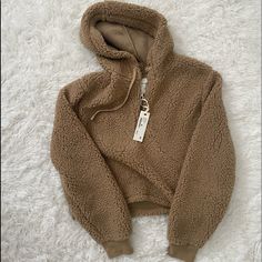 A Fluffy, Warm Pullover Hoodie In Mint Condition With Tags! Perfect For Chilly Days, It’s A Little Cropped So Pairs Well With High Waisted Or Mid Rise Jeans. Warm Cozy Fit Hoodie, Cozy Sweatshirt For Cold Weather, Trendy Brown Hooded Sweater, Brown Winter Tops With Drawstring Hood, Brown Tops With Drawstring Hood For Winter, Brown Drawstring Hood Top For Winter, Beige Fleece Top For Winter, Beige Fleece Tops For Winter, Beige Fleece Winter Top