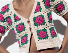 a crocheted top with pink and green flowers on the back, is shown