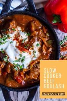 a skillet filled with meat and vegetables covered in sour cream