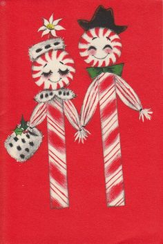 two candy canes are decorated with snowmen and christmas decorations on a red background