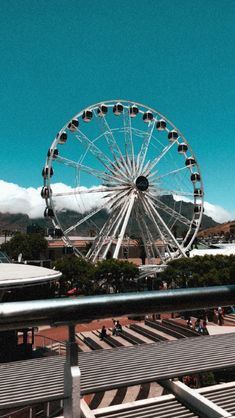 a ferris wheel sitting on top of a metal pole