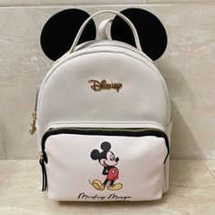 Brand New With Tags!! Disney Mickey Mouse With Ears Backpack Adjustable Shoulder Straps Top Handle Disney Mickey Head Shaped Zipper Pull Interior Zipper Pocket Zip Top Front Zippered Pocket 10”H X 8.5”L X 4”D Primark Exclusive! White Disney Backpack For School, Disney White Backpack For School, White Disney Travel Backpack, White Disney Backpack For Back To School, Disney White Backpack For Back To School, Disney Leather Backpack For Disney Trips, Disney Leather Backpack For School, Disney Leather School Bags, Disney Leather School Backpack