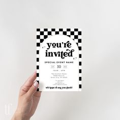 a hand holding up a black and white business card with the words you're involved on it