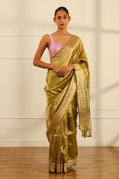 Olive green handwoven tissue silk saree with a floral pattern border. Comes with an unstitched blouse piece. - Aza Fashions Festive Pista Green Handloom Pre-draped Saree, Pista Green Raw Silk Pre-draped Saree For Diwali, Festive Pre-draped Saree With Zari Weaving In Slub Silk, Festive Silk Pre-draped Saree With Self Design, Festive Pista Green Tussar Silk Pre-draped Saree, Festive Slub Silk Pre-draped Saree For Puja, Gold Tussar Silk Fitted Saree, Gold Slub Silk Pre-draped Saree For Navratri, Fitted Gold Tussar Silk Saree