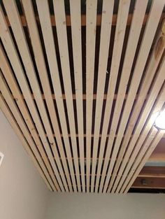 an unfinished ceiling with wooden slats on it