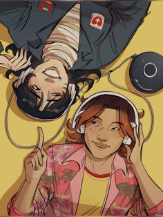 two people laying on the ground with headphones