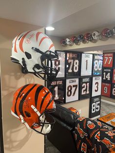 a helmet and football helmets are on display in the locker room at an orange zone