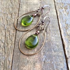 Green Czech Glass Teardrop and Copper hoop earrings.Spring green Czech glass teardrops dangle inside of a hand forged, antiqued copper hoop. Very light weight and a perfect color for spring and summer outfits!Product overview:- Made with Czech glass teardrops and antiqued copper- Total hanging length of 2" including ear wire- Light weight and versatile- Hypoallergenic, lead and nickel free ear wires Chartreuse Jewelry, Chartreuse Earrings, Jewelry Repurposed, Green Chartreuse, Boho Hoop Earrings, Earthy Jewelry, Turquoise Hoop Earrings, Natural Stone Earrings, Turquoise Earrings Dangle