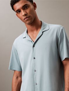 Our premium collection. Elevated loungewear with a luxurious feel, this sleep button-down shirt is crafted from a cotton modal stretch blend for an extra soft touch. Designed with short sleeves and a notch collar. Styled with drop shoulders for a relaxed, effortless fit.  Material: 55% Cotton, 37% Modal, 8% Elastane. Elevated Loungewear, Button Down Sleep Shirt, Notch Collar, Sleep Shirt, Black Button, Button Downs, Calvin Klein, Button Down Shirt, Lounge Wear