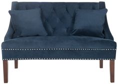 a blue velvet couch with studded trimmings on the arms and back, in front of a white background