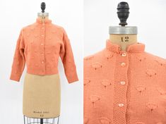 "Vintage 1950s wool knit. Vibrant creamsicle orange. Fan design throughout. Long sleeves and high 1 1/2\" collar. Front button closure. Unlined.  State of garment | excellent  Measurements ✂--- Best fit |  Large *has give Bust | up to 38-40 \" Shoulders | not specified / apron 15\" Shoulder to waist | not specified  Sleeves | aprox 19 \" Waist | 30.5- 32\" Total length (shoulder to hem) | 19 1/4\" Tag | none present  ★★Visit The Shop★★ http://www.etsy.com/shop/seaofvintage ➸ Find the shop on Ins Retro Fitted Sweater With Button Closure, Fitted Vintage Wool Sweater, Fitted Wool Sweater In Vintage Style, Vintage Orange Sweater For Fall, Retro Orange Cardigan For Winter, Retro Orange Winter Cardigan, Vintage Wool Sweater For Spring, Fitted Wool Vintage Cardigan, Vintage Fitted Sweater With Buttons