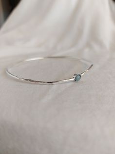 "The Sterling silver bangle bracelet is perfect in its simplicity. Hammered bangle for women. For a modern and trendy look. 4mm. natural Aquamarine stone set in a decorated stone house. Choose your length look at the picture to know how to take the right size. for other lengths please convo me. Very important! to avoid mistakes, please make sure you have the right size. If you not sure then look at item photos and learn how to do it. x-small - 2.25\" diameter 7.5\"circumference small - 2.5\" dia Silver Birthstone Bangle Jewelry, Stackable Sterling Silver Bangle Bracelet As Gift, Sterling Silver Stackable Bangle Bracelet Gift, Sterling Silver Bangle Bracelet With Simple Design, Simple Bangle Bracelets As Gifts, Simple Bangle Bracelet As Gift, Simple Design Bangle Bracelet For Gift, Sterling Silver Bangle Bracelet For Gift, Silver Slim Band Bracelet For Gift